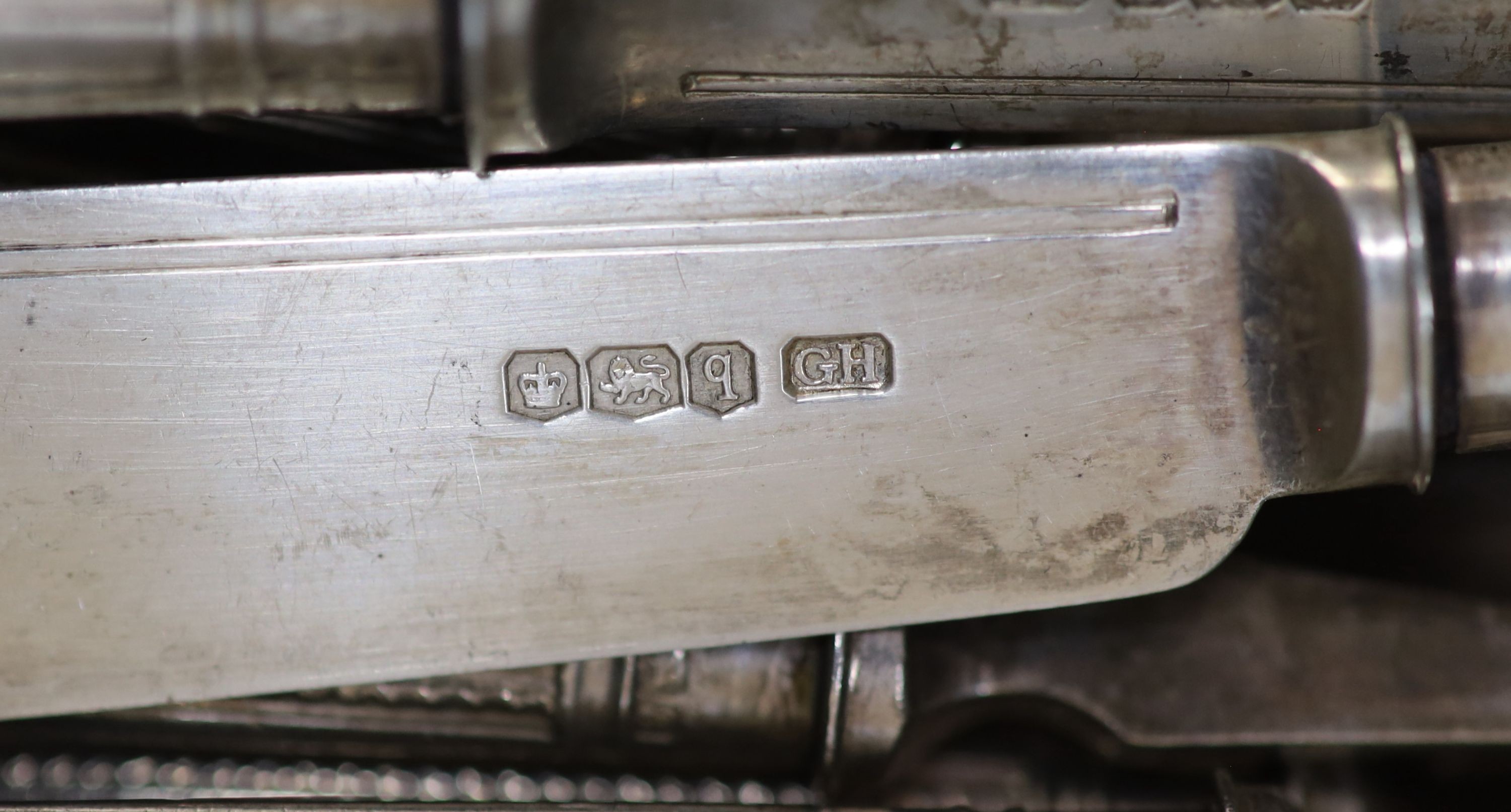 Twelve George V silver fish forks and eleven matching fish knives, George Howson, Sheffield, 1933, loaded handles.